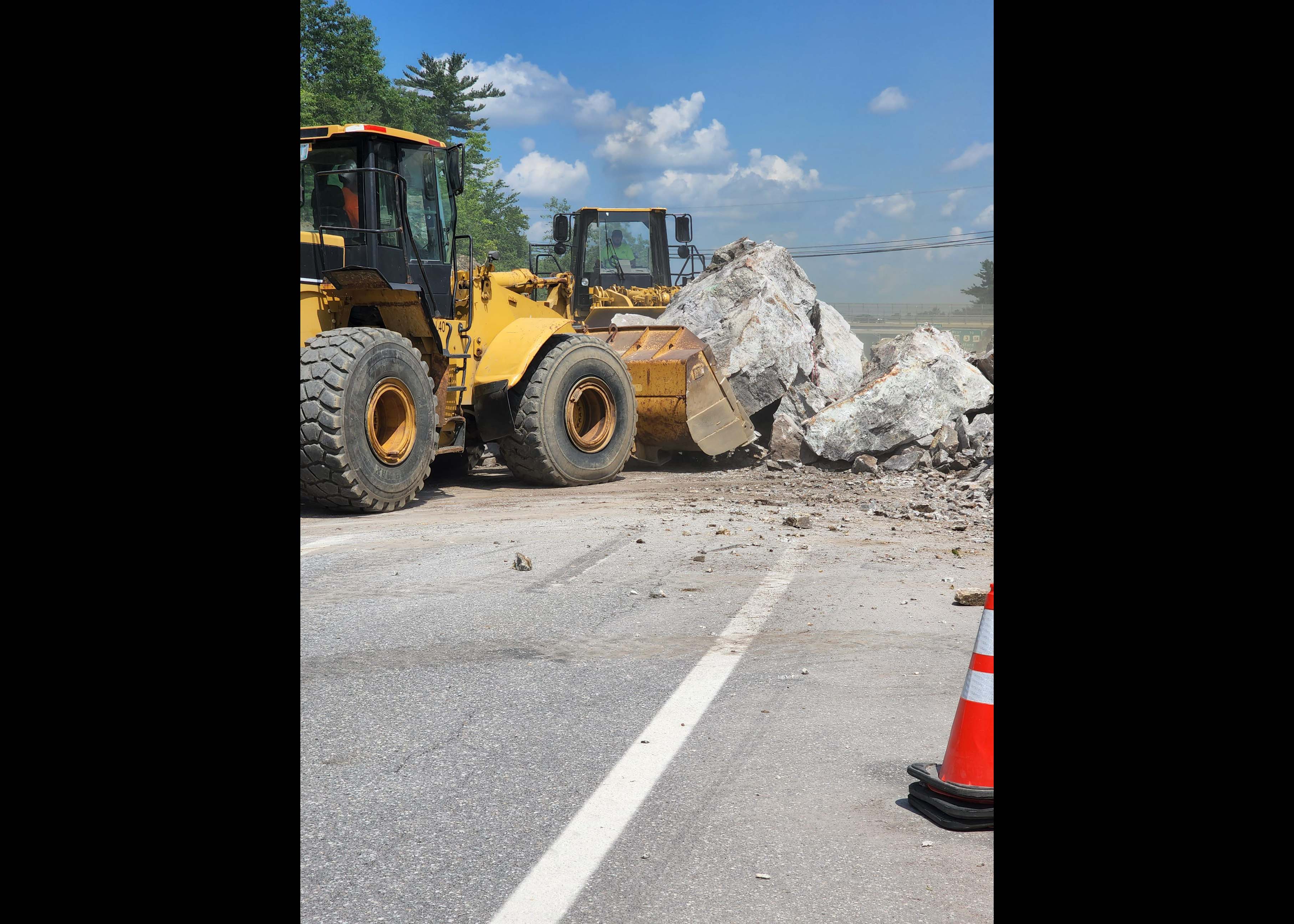 Rock being removed from the road after a blast - August 2022